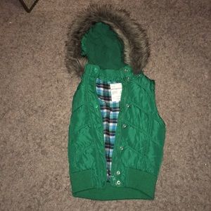 This is a teens girl vest in the color green.
